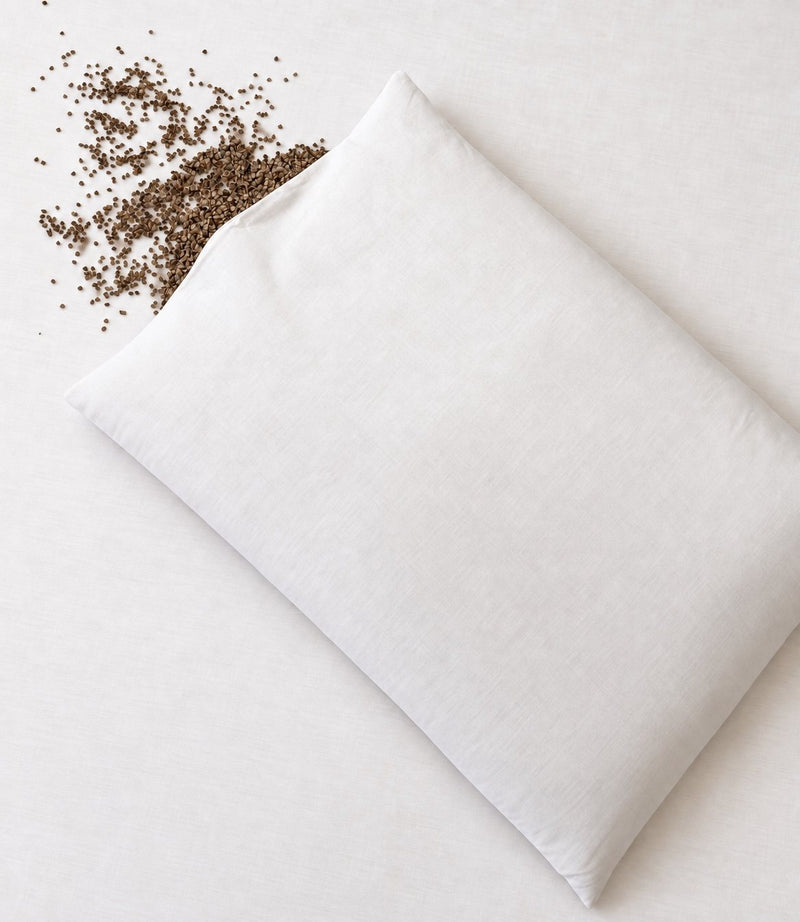 No Fluff organic buckwheat pillow with buckwheat hulls spilling from the opening